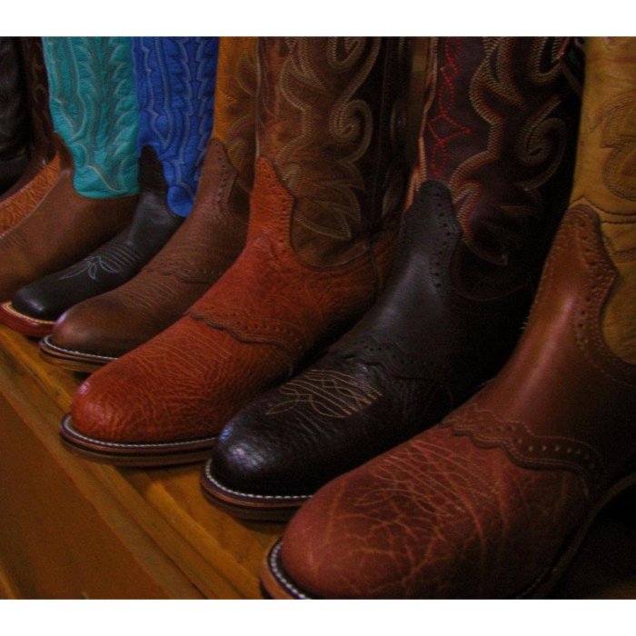 A lineup of colorful cowboy boots on display at Davis Clothing Company